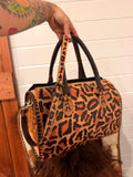 “Western Cheetah” tooled leather speedy duffle (L) by The Painted Porches