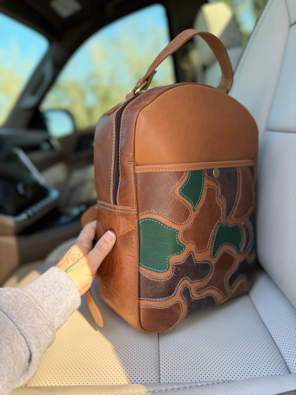 The “Hunter” camo leather bookbag by the Painted Porches