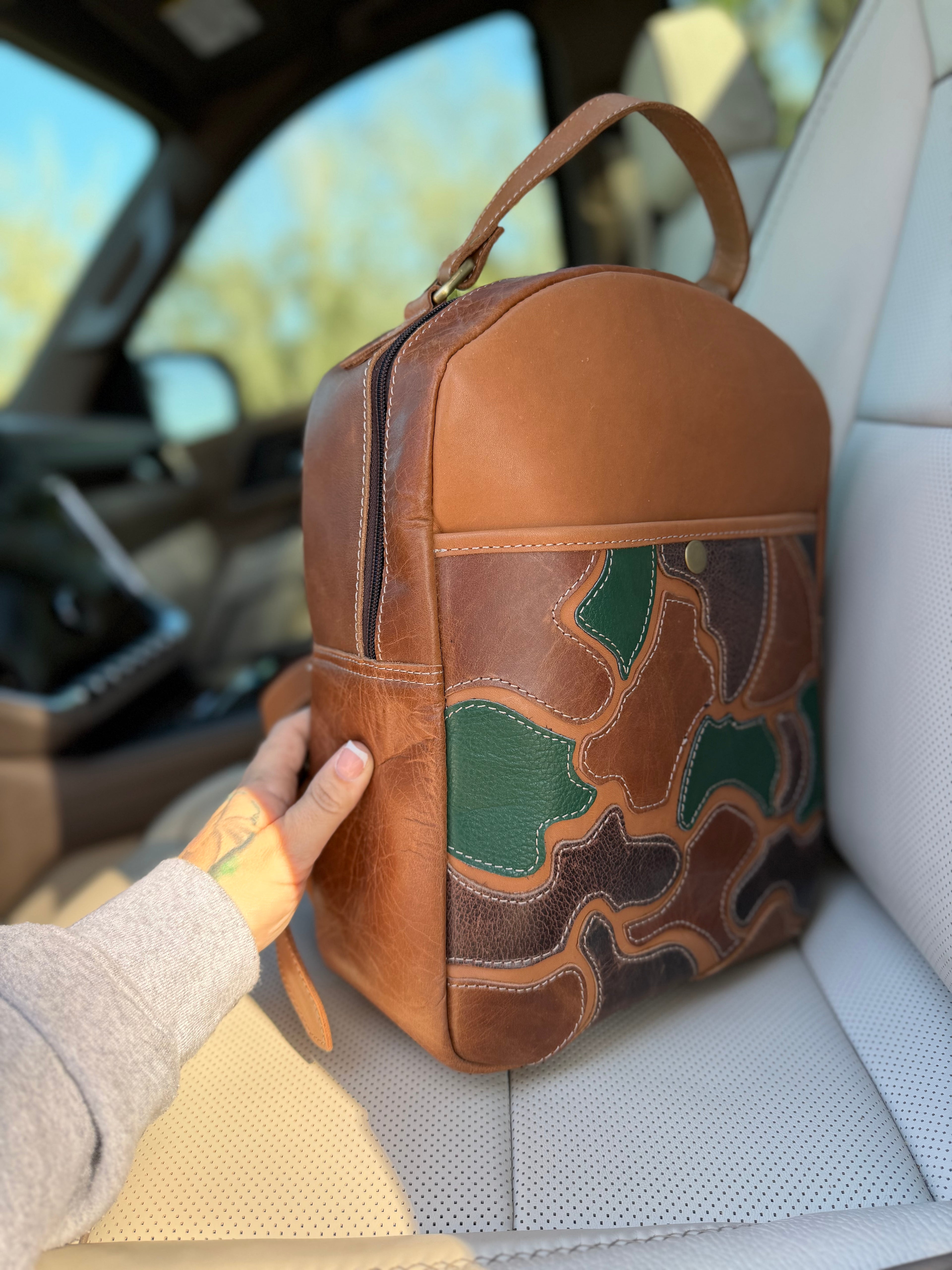 The “Hunter” camo leather bookbag by the Painted Porches