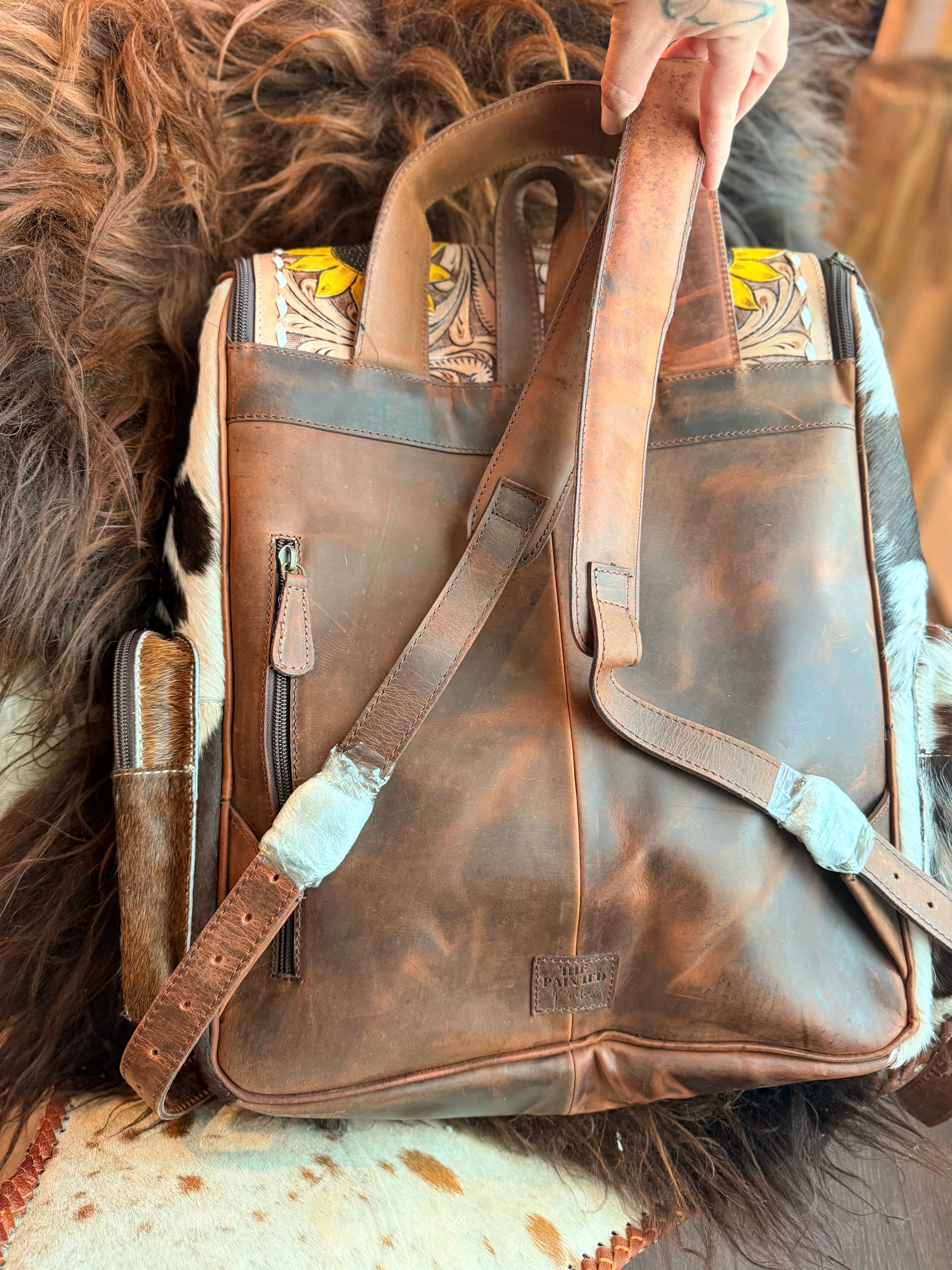 Tooled leather bookbag