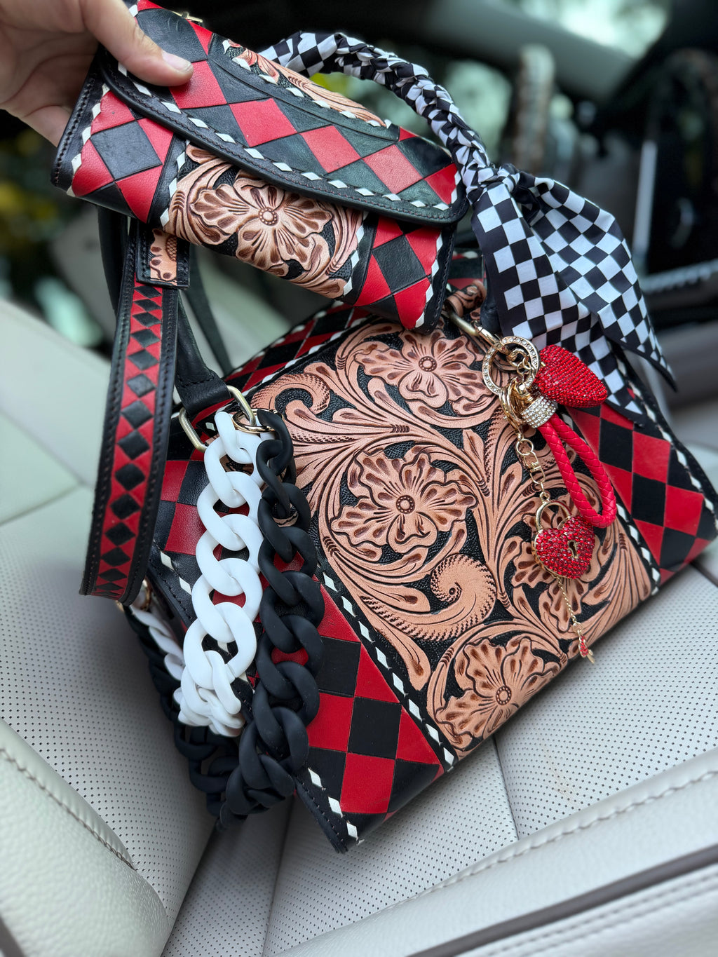 “Harlequin Heiress” red/black check and tooled leather speedy (L) by the Painted Porches