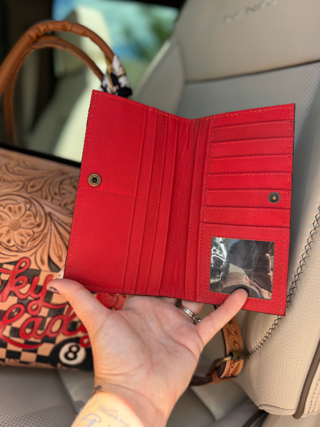 “The Outlaw Gambler” tooled leather speedy (L) by the Painted Porches