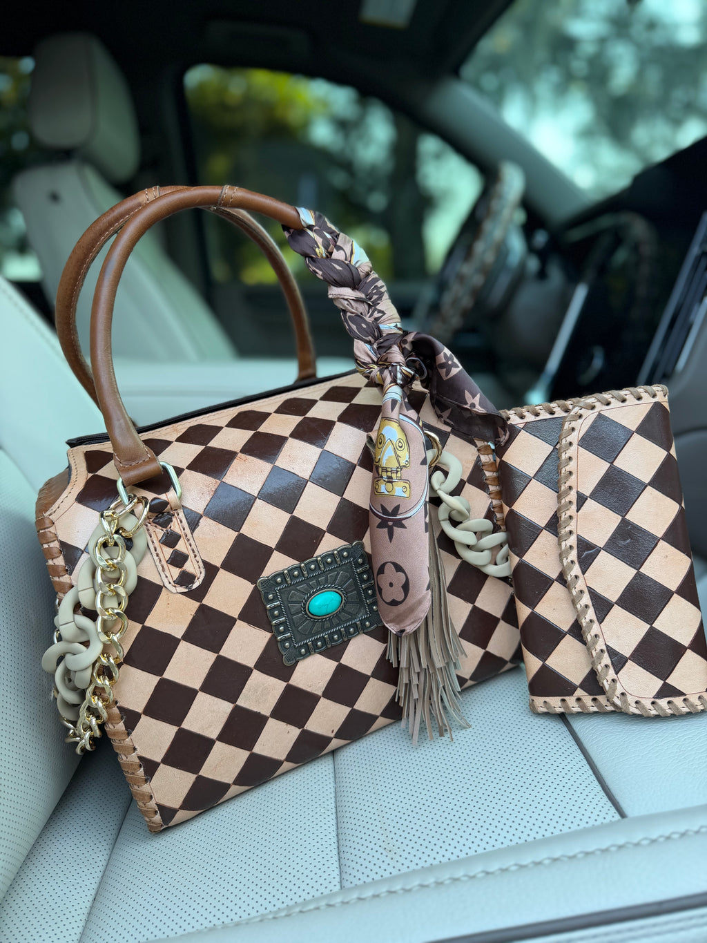 “Cowgirl Couture” peanut butter checker tooled leather speedy (L) by the Painted Porches