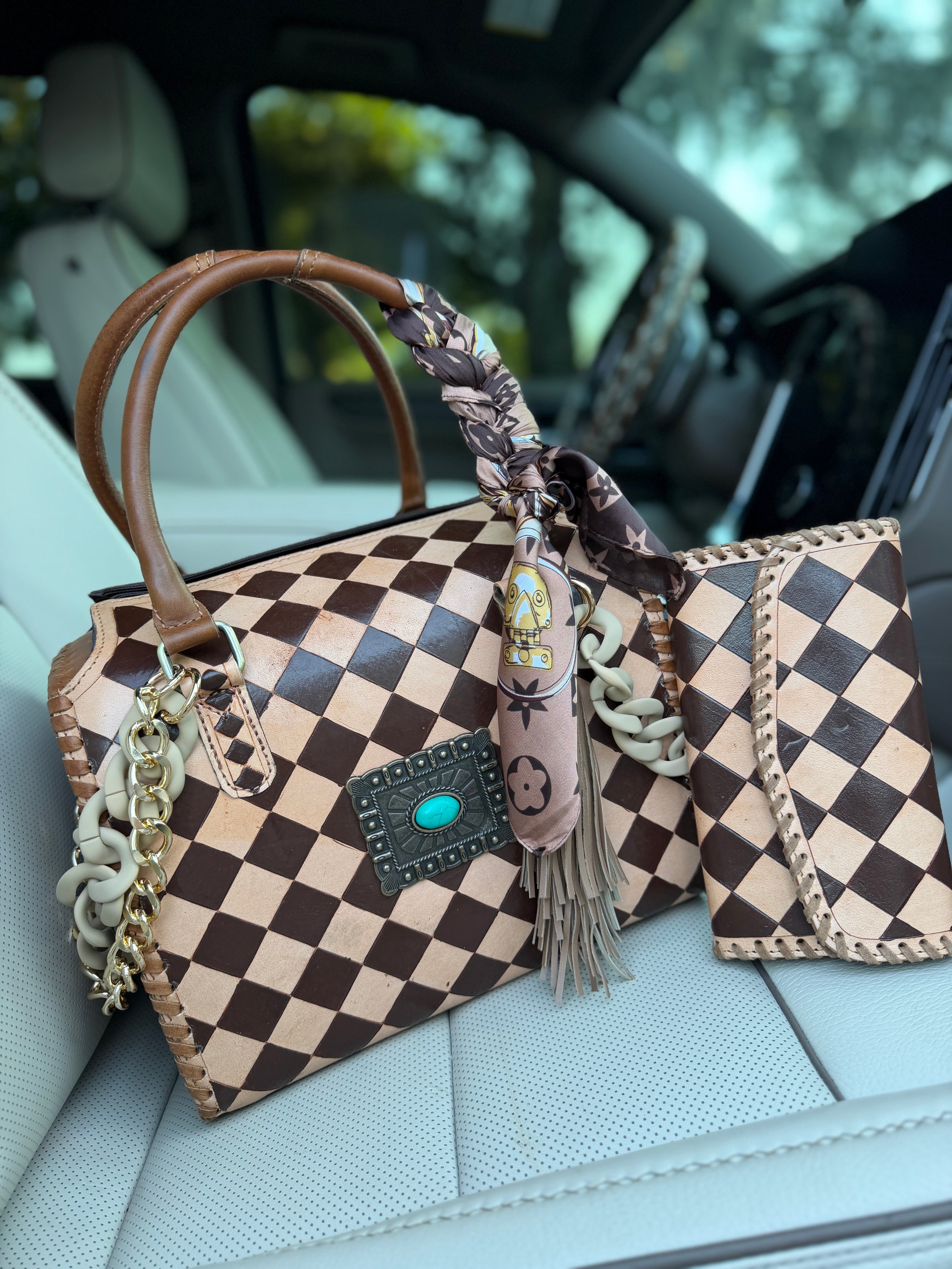 “Cowgirl Couture” peanut butter checker tooled leather speedy (L) by the Painted Porches