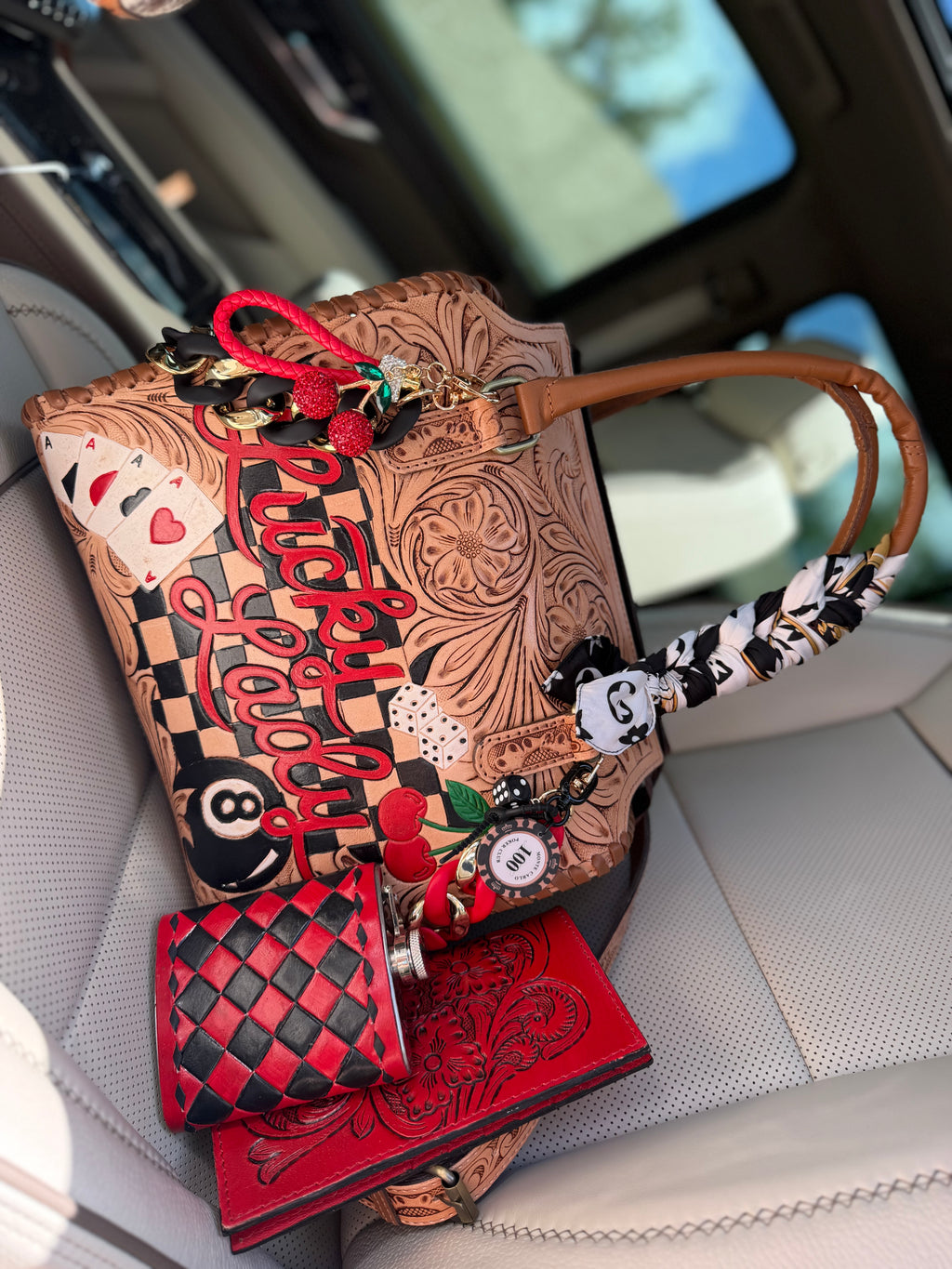 “The Outlaw Gambler” tooled leather speedy (L) by the Painted Porches