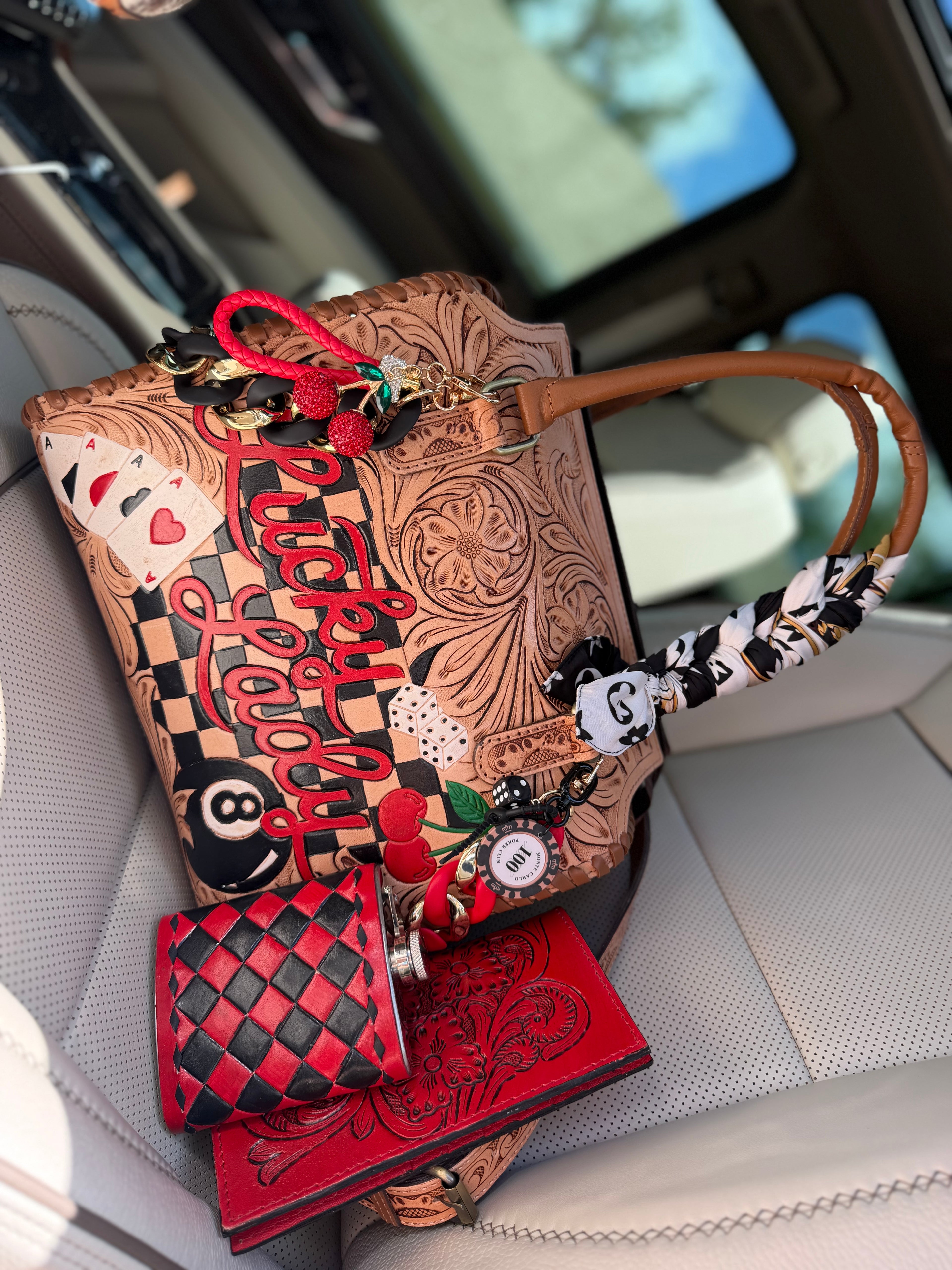 “The Outlaw Gambler” tooled leather speedy (L) by the Painted Porches