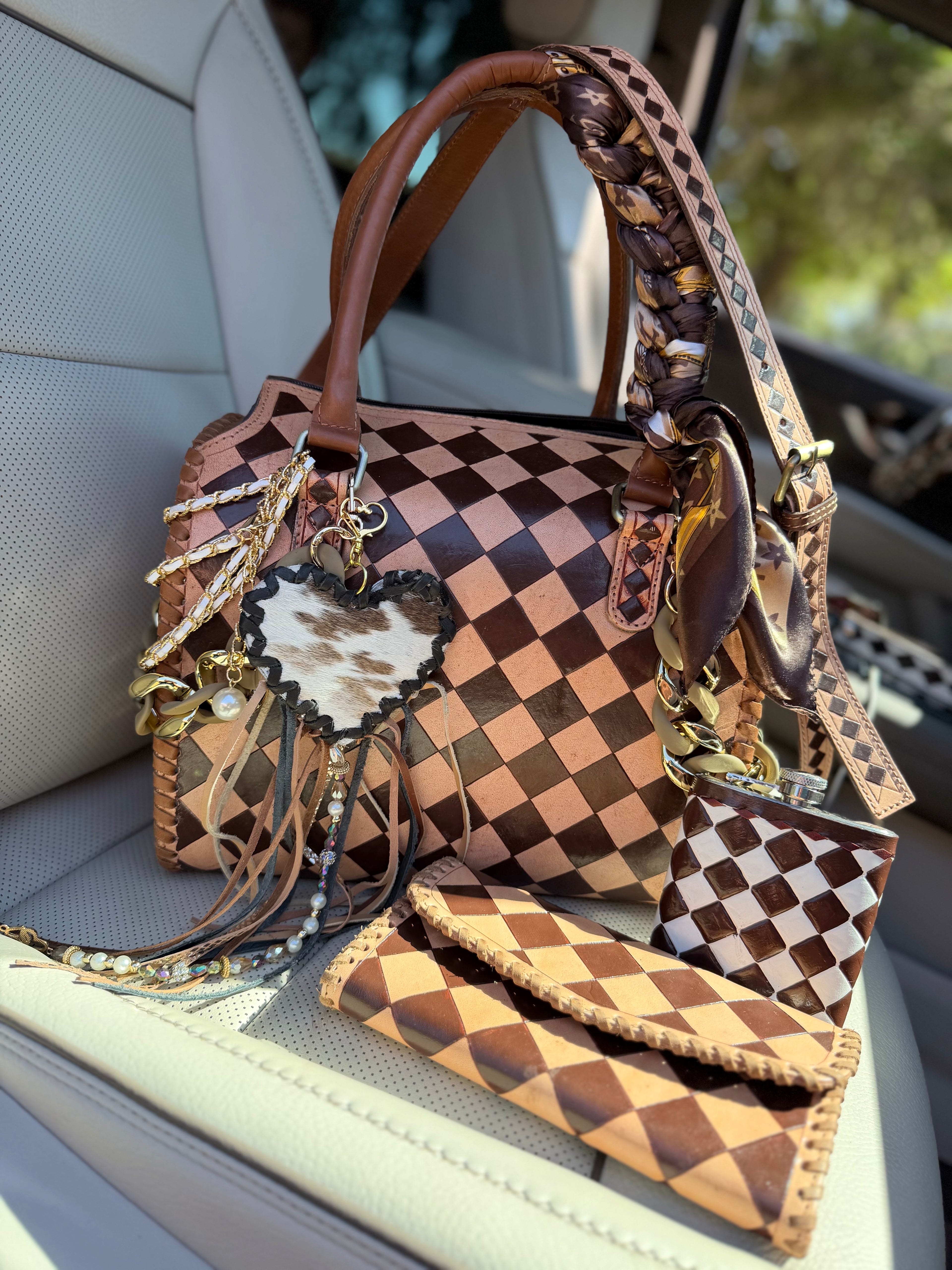 “Champagne and Spurs” peanut butter checker tooled leather speedy (L) by the Painted Porches
