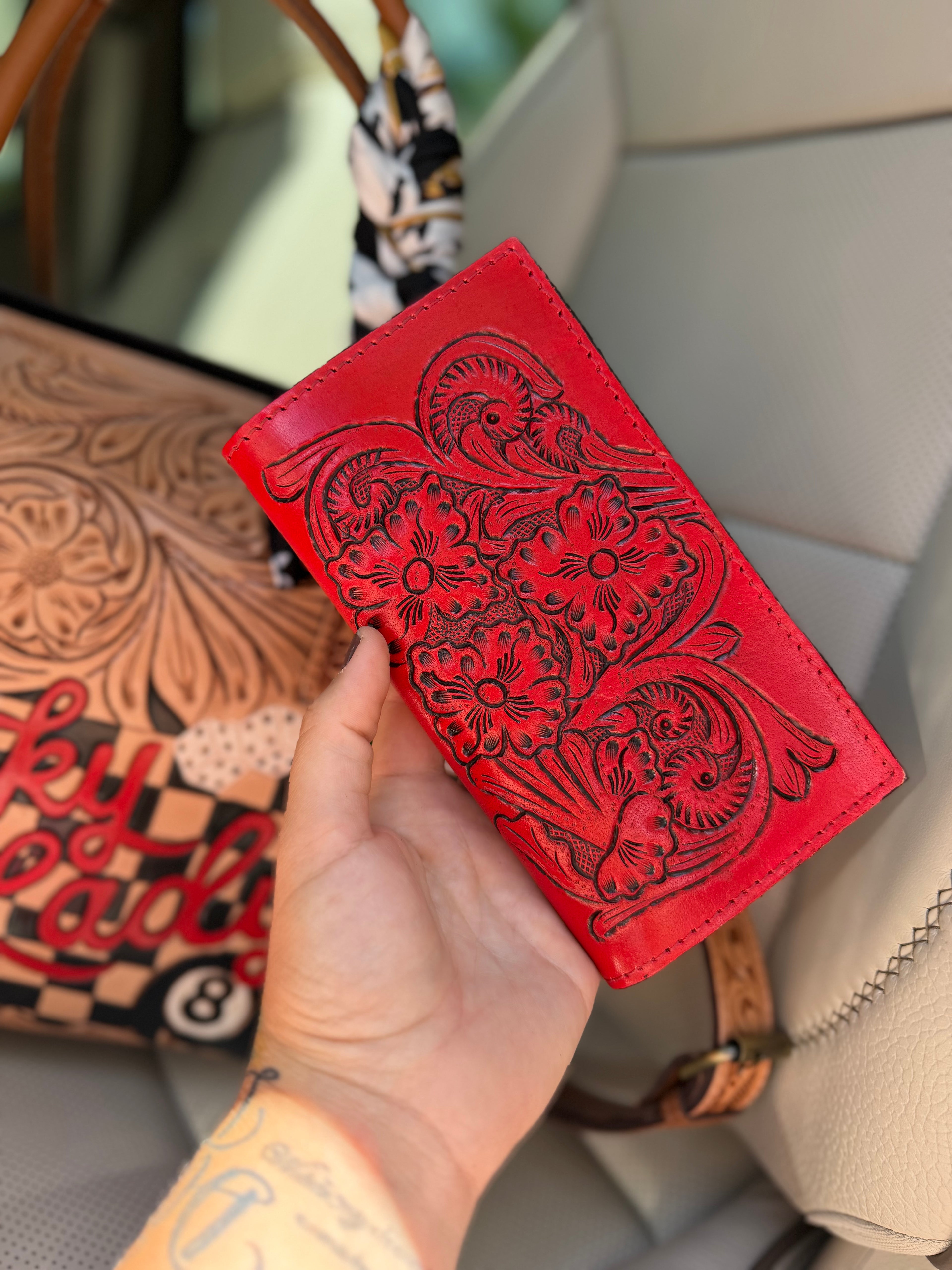 “The Outlaw Gambler” tooled leather speedy (L) by the Painted Porches