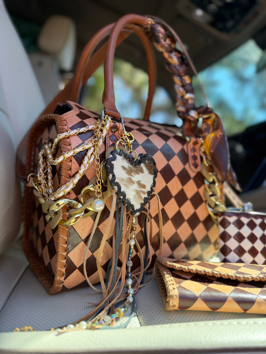 “Champagne and Spurs” peanut butter checker tooled leather speedy (L) by the Painted Porches